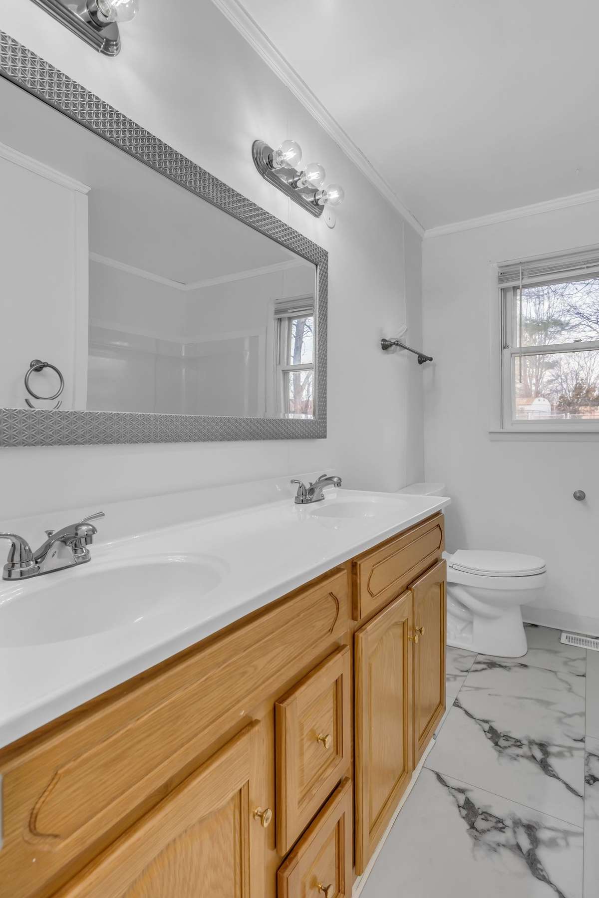 Double vanities in hallway bathroom