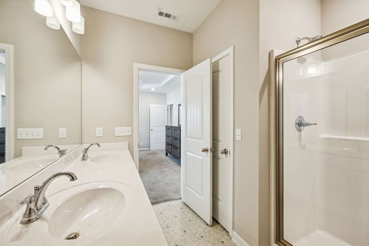 Your primary bath features a double vanity, enclosed shower, and a linen closet for added storage! 501 Ruby Cate Way, Murfreesboro, TN 37128