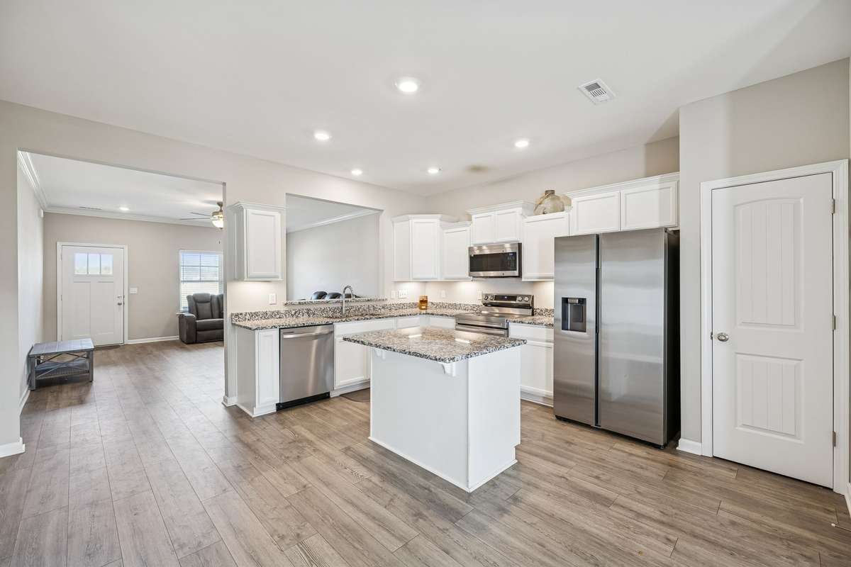 Open-concept kitchen with granite topped countertops and island! 501 Ruby Cate Way, Murfreesboro, TN 37128