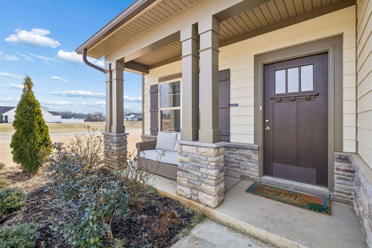 Welcoming, covered porch with a combination of fiber cement board, stonework, and vinyl comprising the exterior! 501 Ruby Cate Way, Murfreesboro, TN 37128