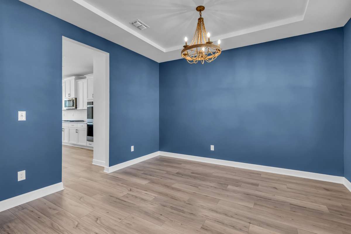 Dining room as you walk in the fron door it's to your right & flows into the kitchen.Beautiful lighting remains.