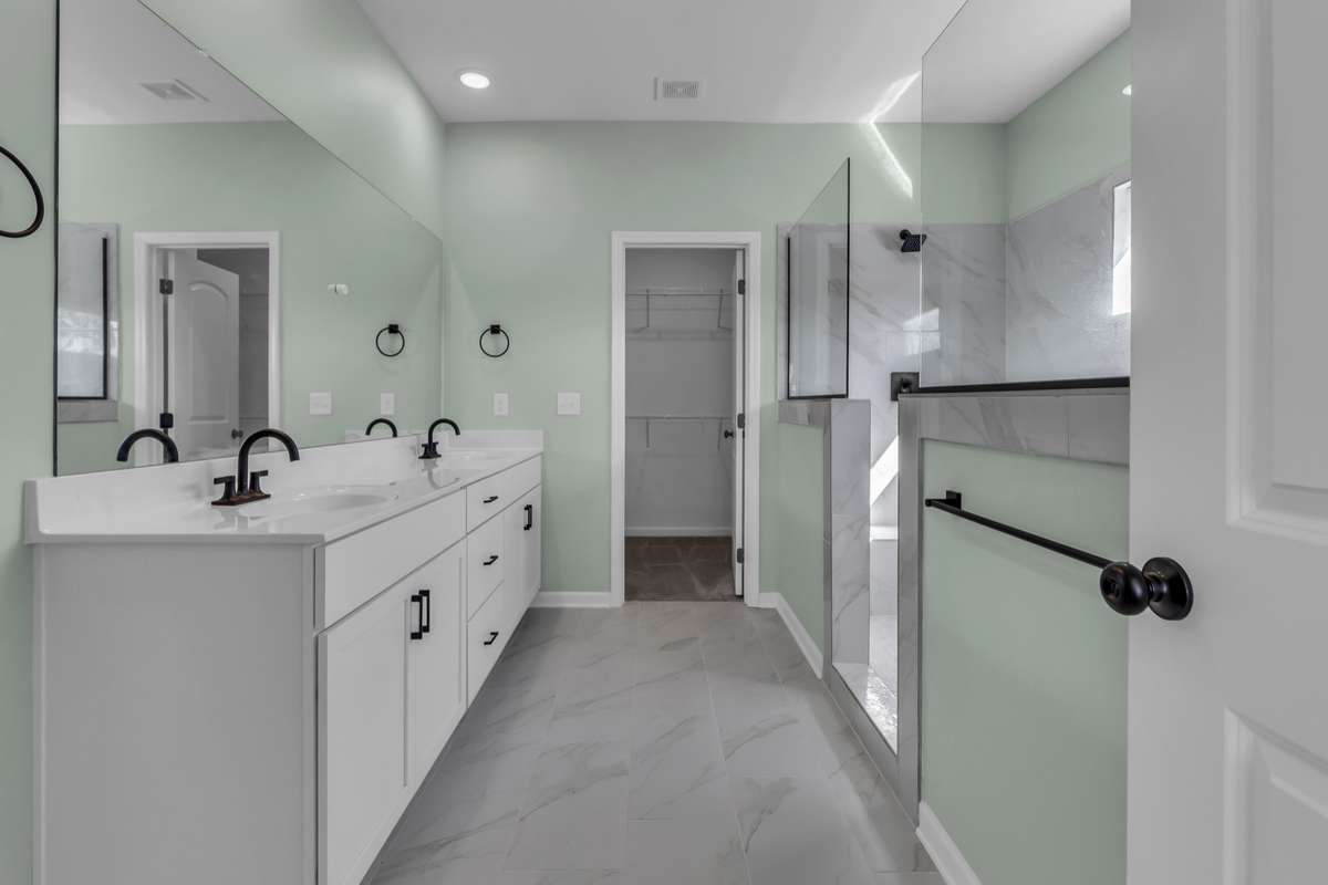 Primary bathroom complete with duel head walk in shower, double vanities and spacious walk in closet.