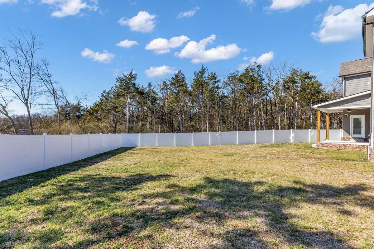 This expansive back yard is fully fenced and backs to beautiful trees for privacy. An irreplaceable feature of this home.