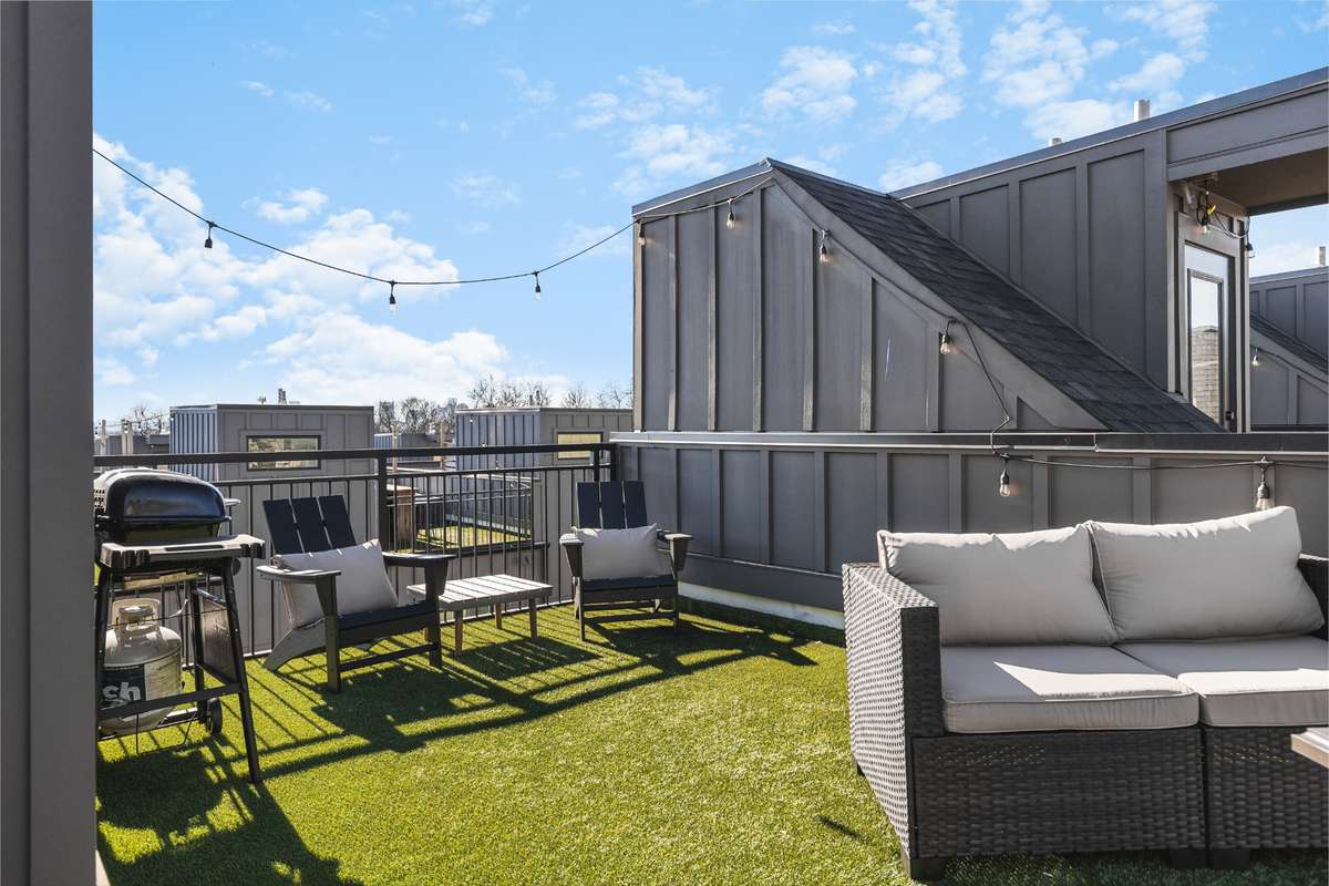 Full rooftop with fire pit and downtown skyline views