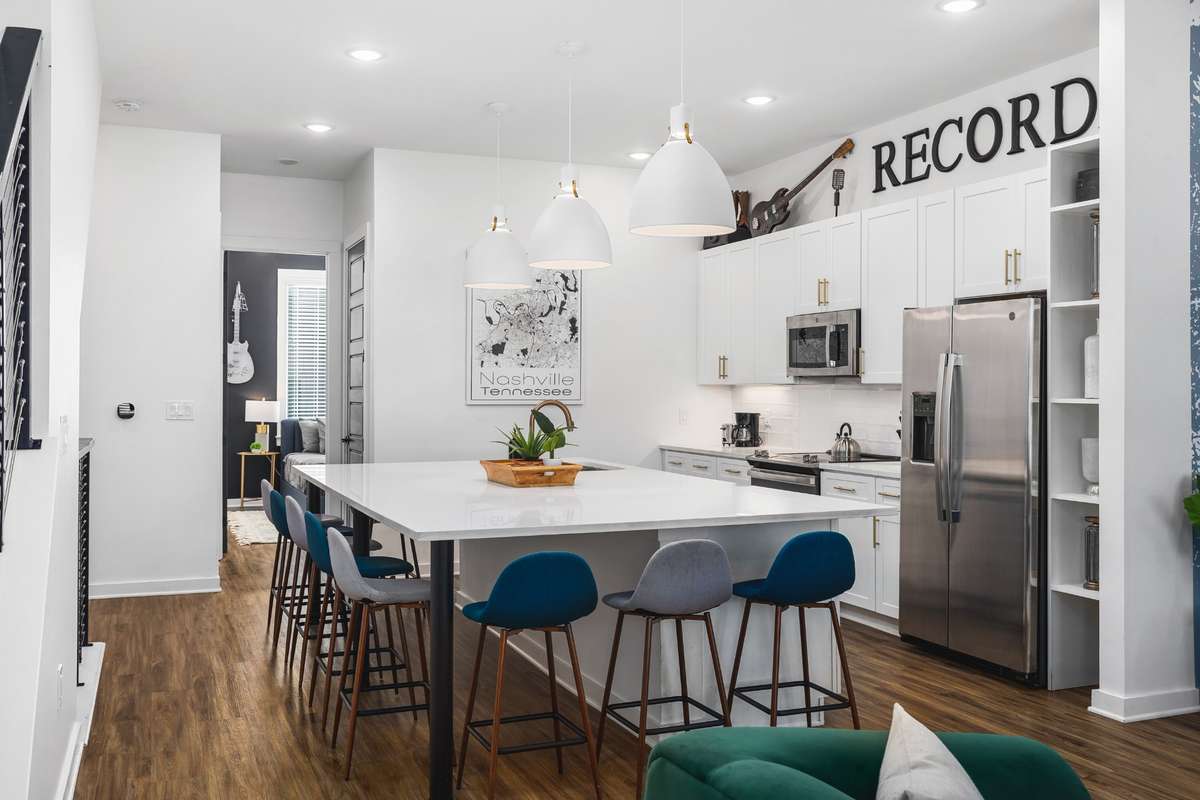 Home has tall ceilings, wooden finish floors, and fresh paint