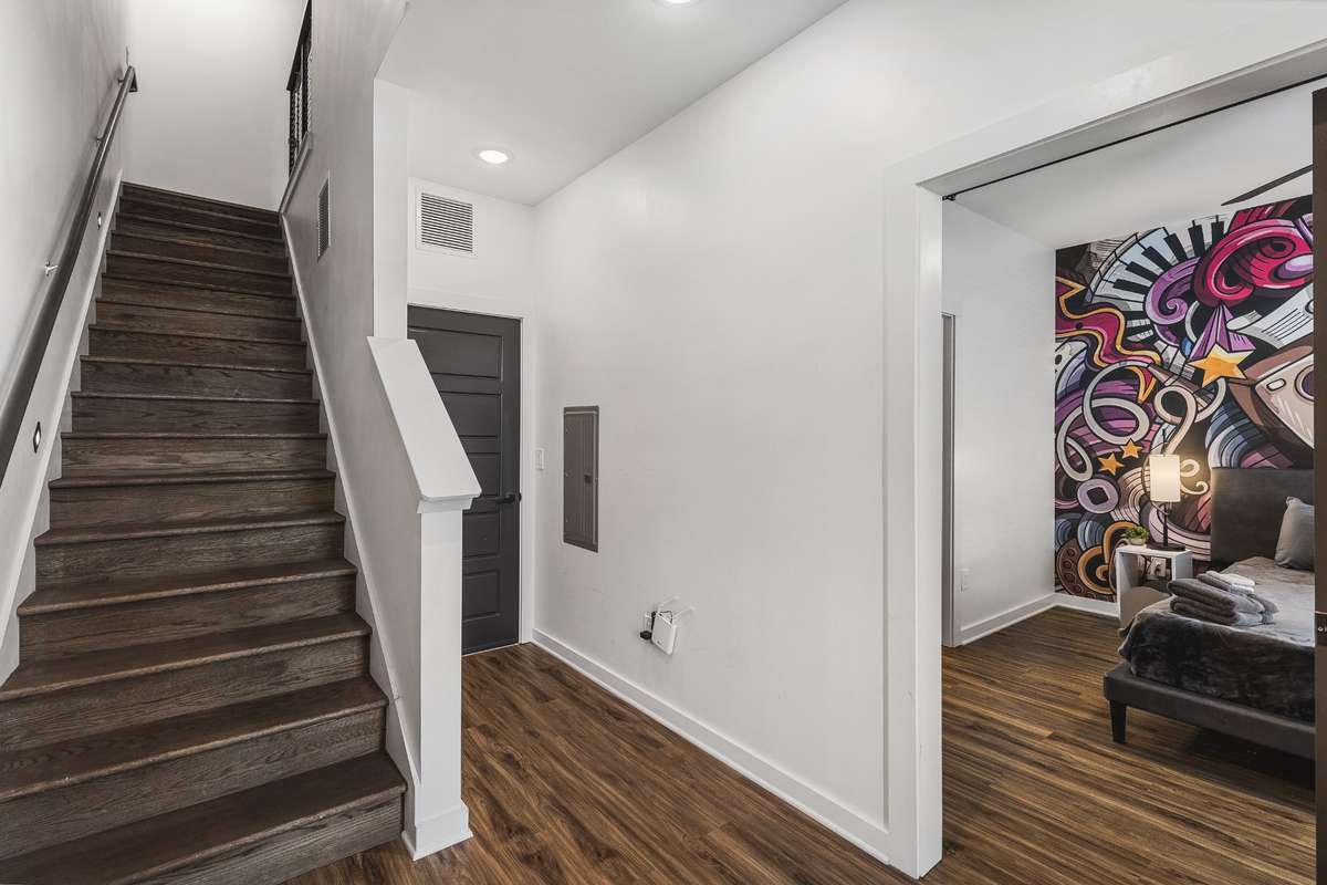 First level - garage door in the back and a first floor bedroom downstairs with a full bath