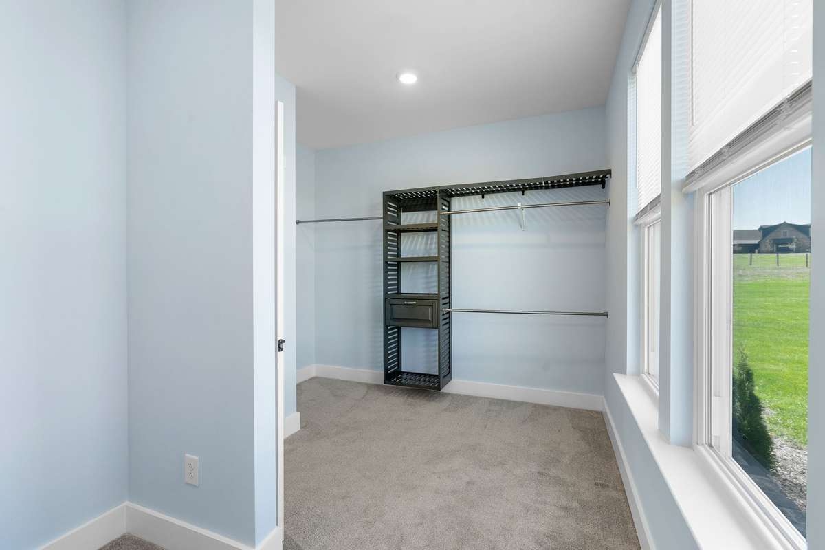 Bright walk-in closet with built-in shelving.
