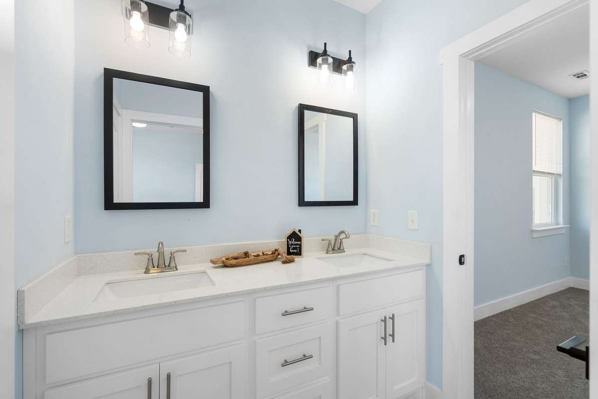 Jack and jill bathroom with dual sinks between bedroom 2 and bedroom 3.