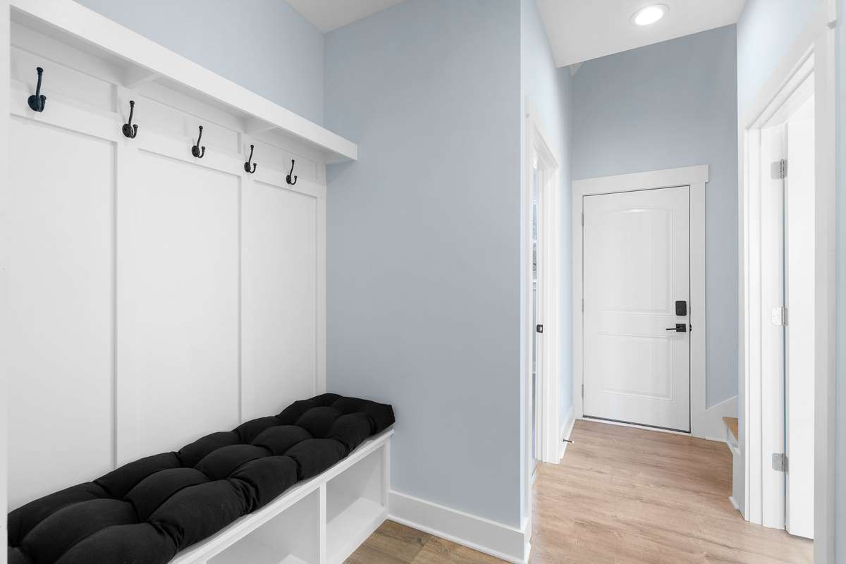 Functional mudroom with built-in bench and wall hooks for extra storage.