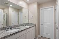 Double vainties with granite tops in primary bathroom