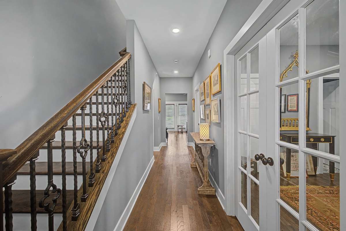 Welcoming entrance with hardwoods, custom rails and molding. Downstairs bedroom that's being used as an office.