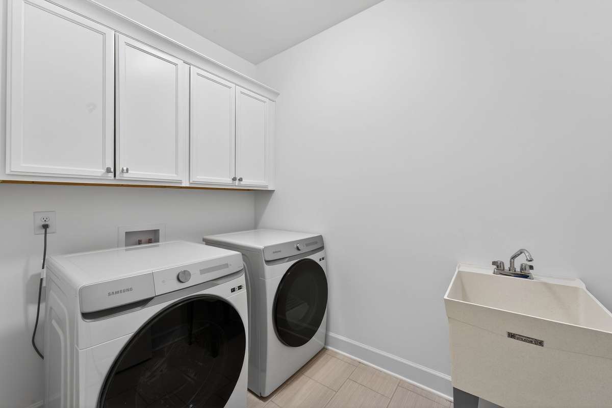 Laudry Room with cabinets and utility sink.