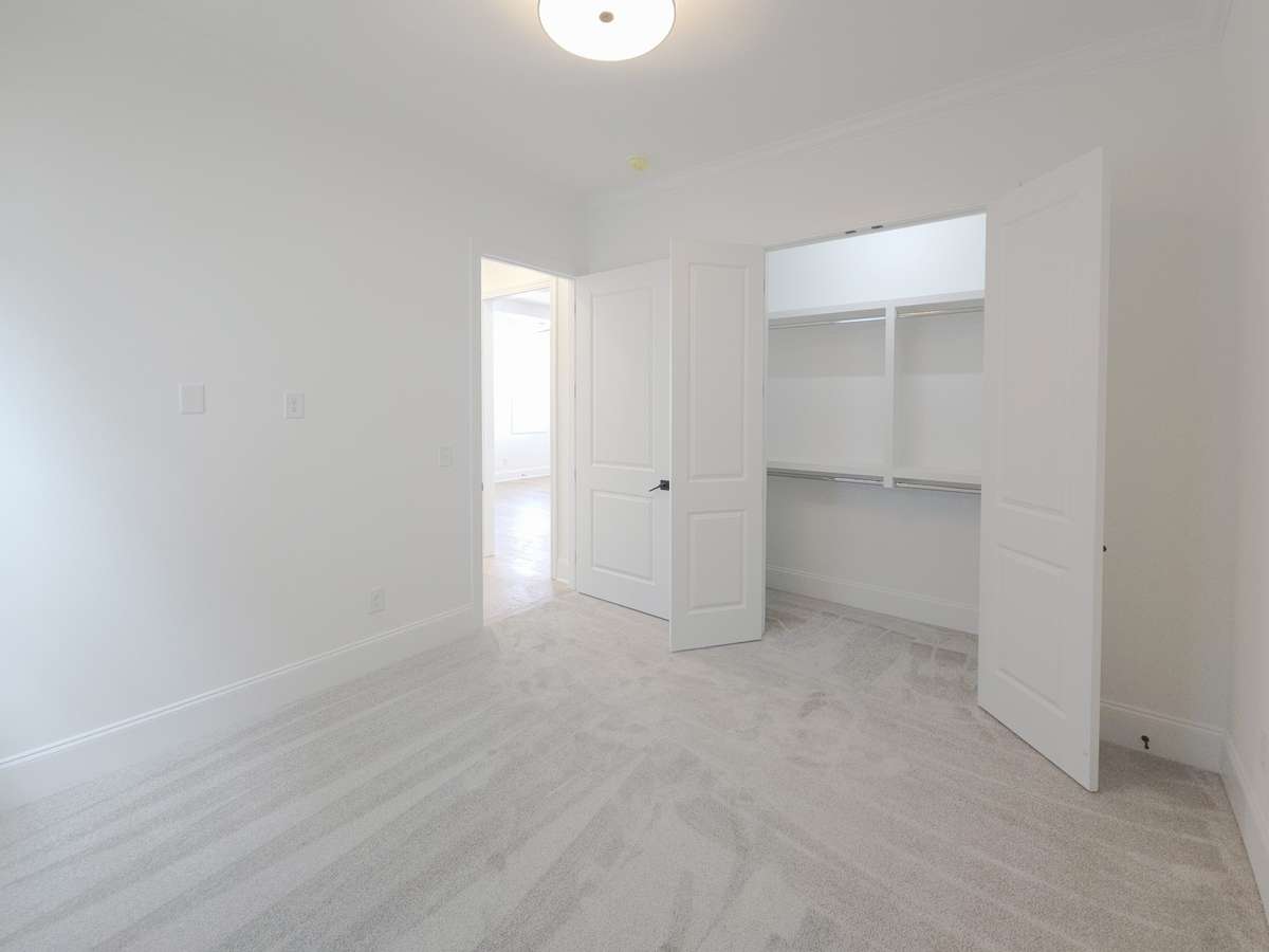 A large closet with built-in shelving makes organization a breeze!