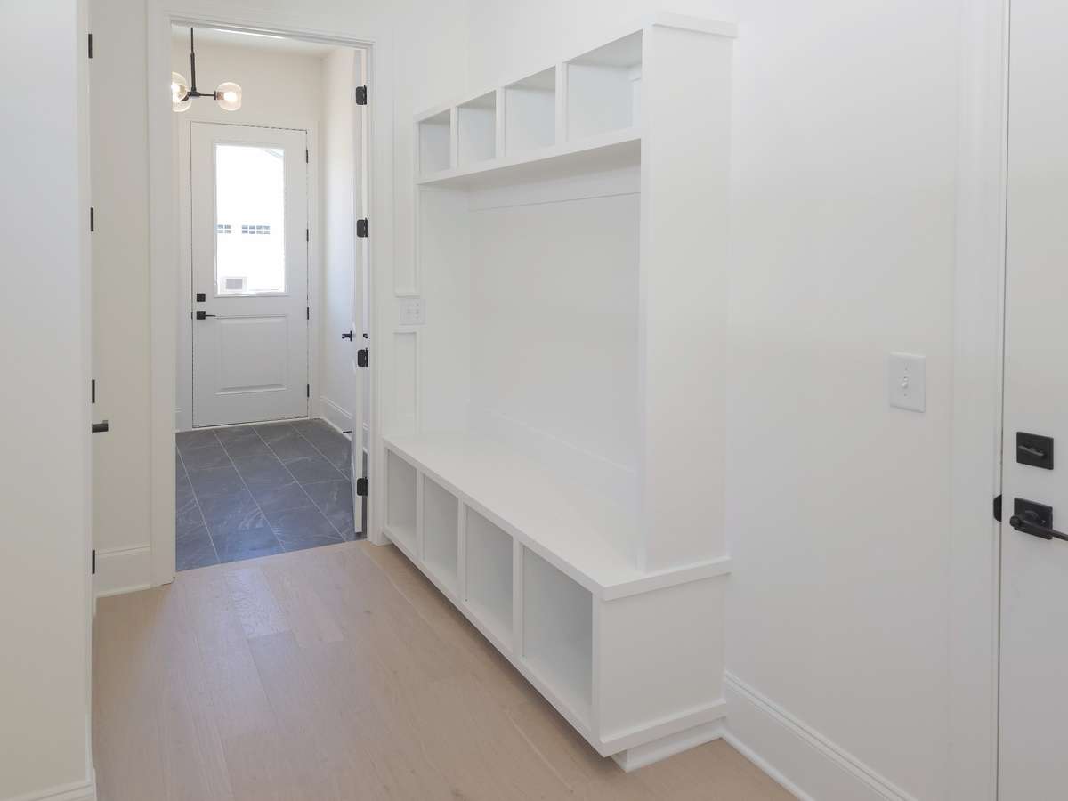 Situated between the utility room and 2-car attached garage, you will find a mud room with built-in storage and a sitting bench