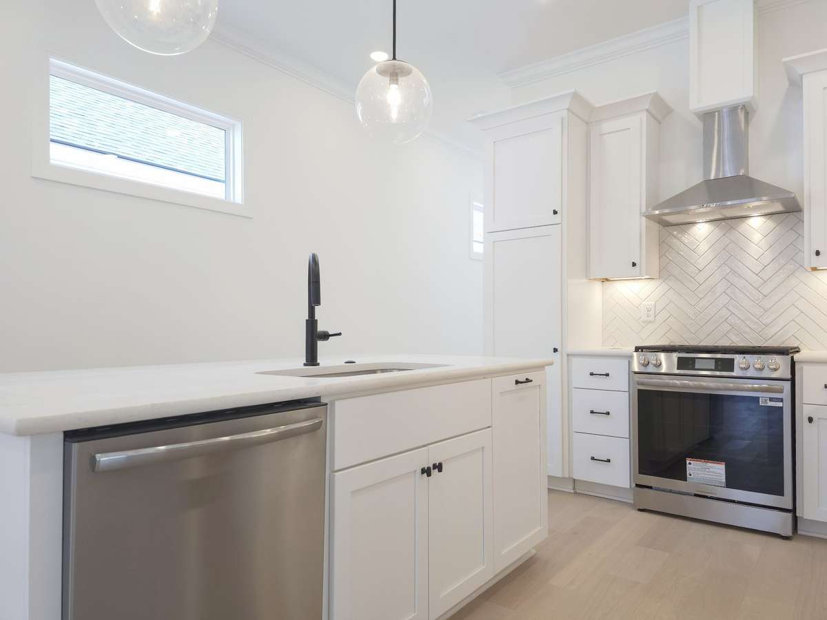The kitchen showcases Frigidaire Gallery® stainless steel appliances and custom maple cabinetry - combining style, function, and modern elegance.