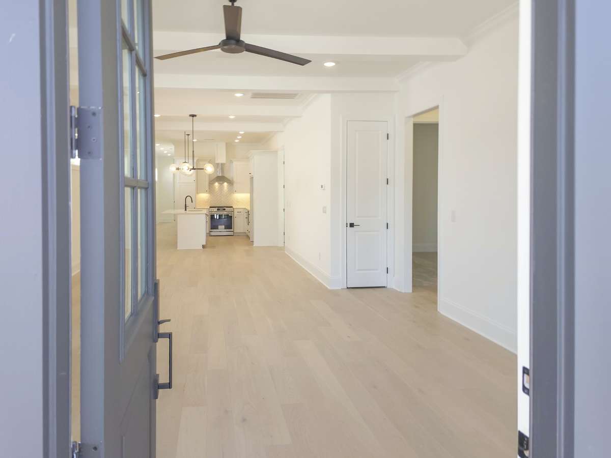 Welcome to The Poplar Plan... notice the beautiful trim work throughout. 7 1/4" baseboards, ceiling beams.