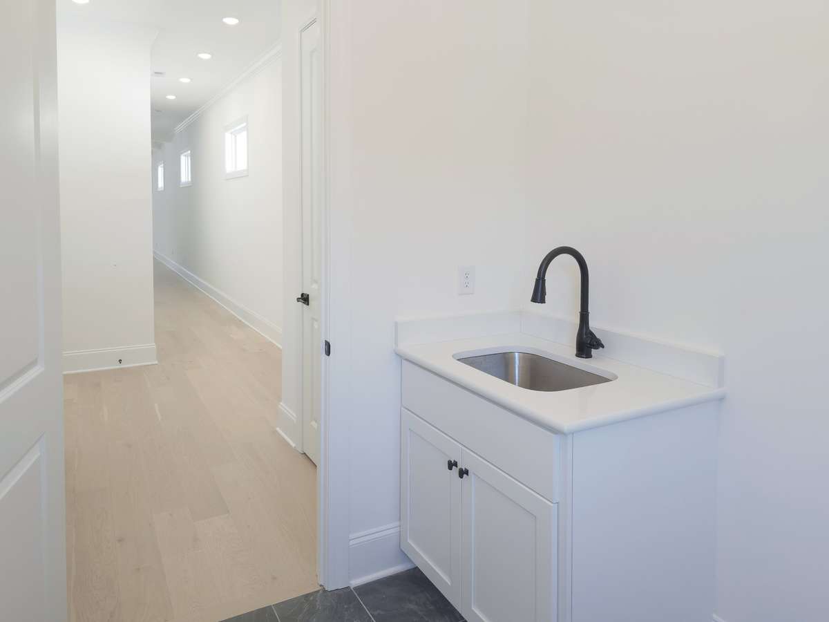 Attached 2-car garage and utility room with rear entrance/exit.