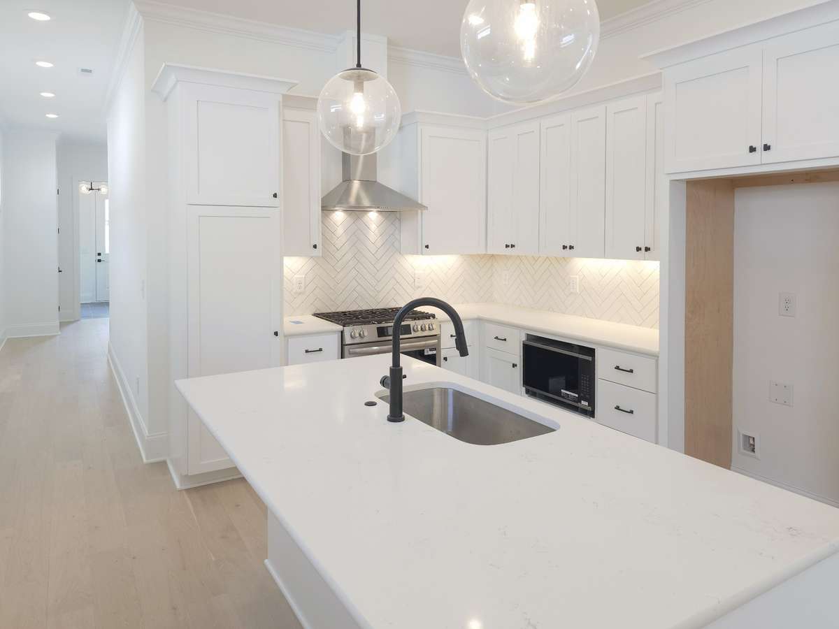 Ample cabinets assure you have the space for all your kitchen needs! - Plus, a large island with barstool seating
