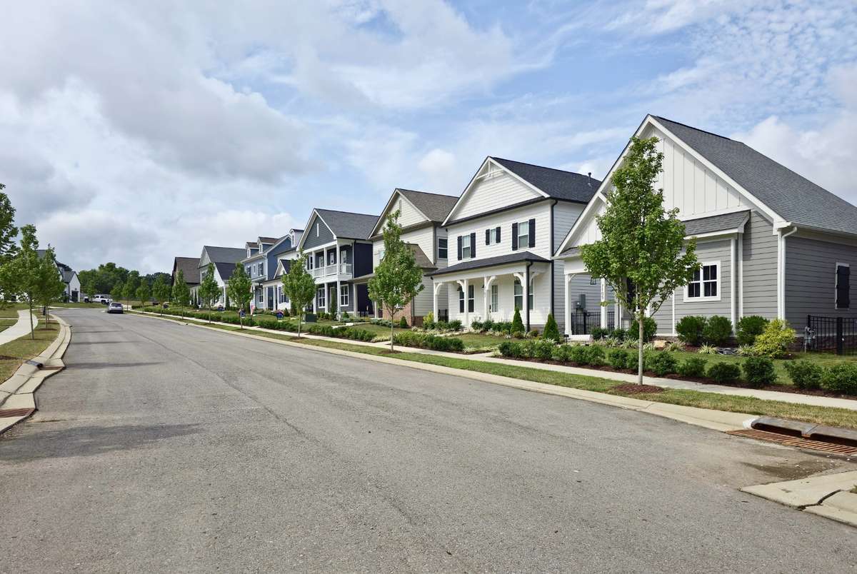 Tree-lined sidewalks wind through the neighborhood, encouraging leisurely strolls and fostering a strong sense of community.