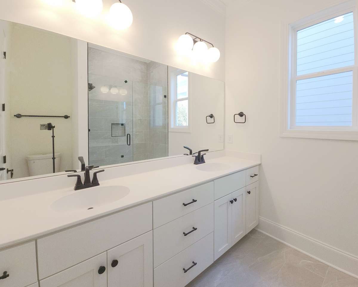 Between rooms 2 and 3, you will find a dual vanity, walk-in shower bath!