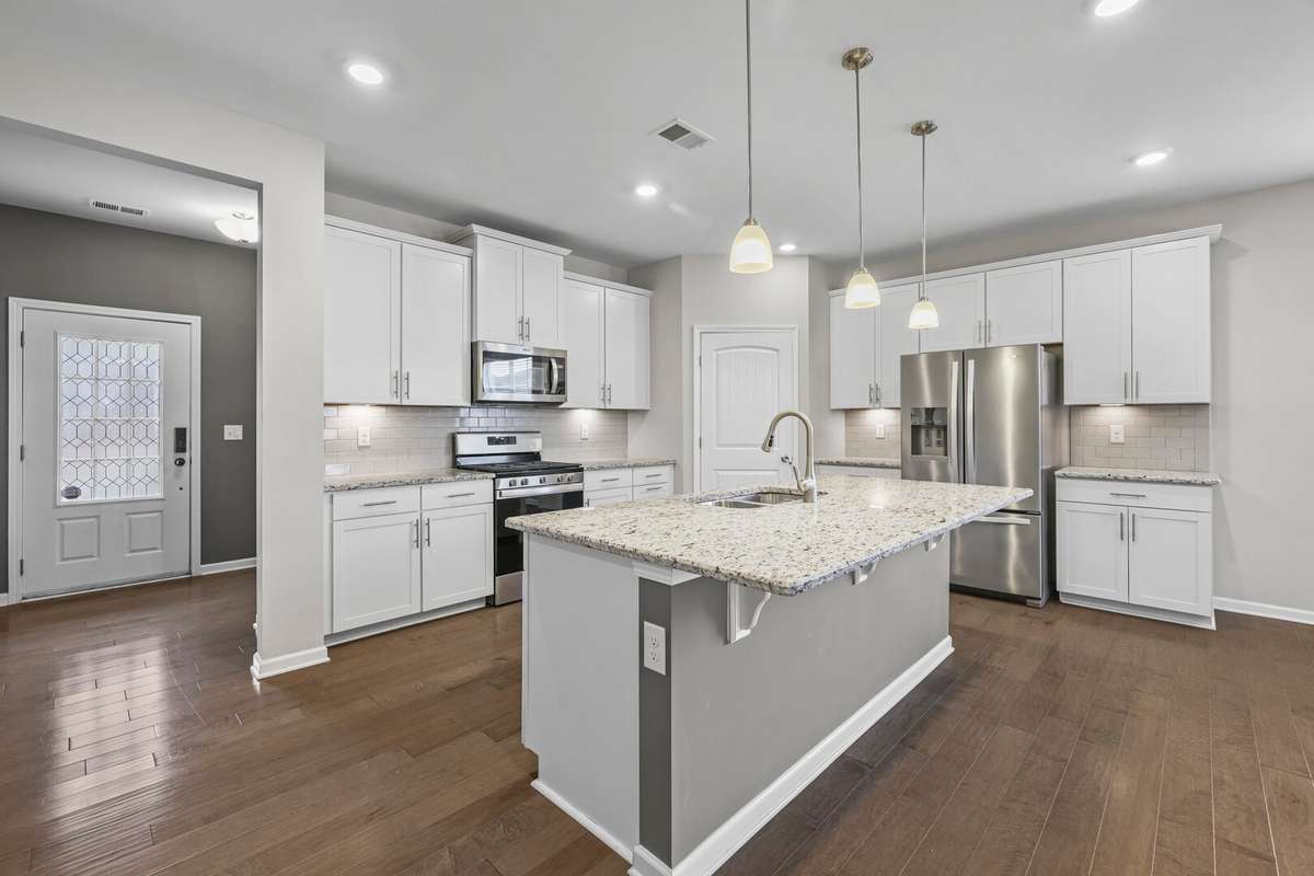 Beautiful kitchen with tons of cabinets, recessed lighting and large island