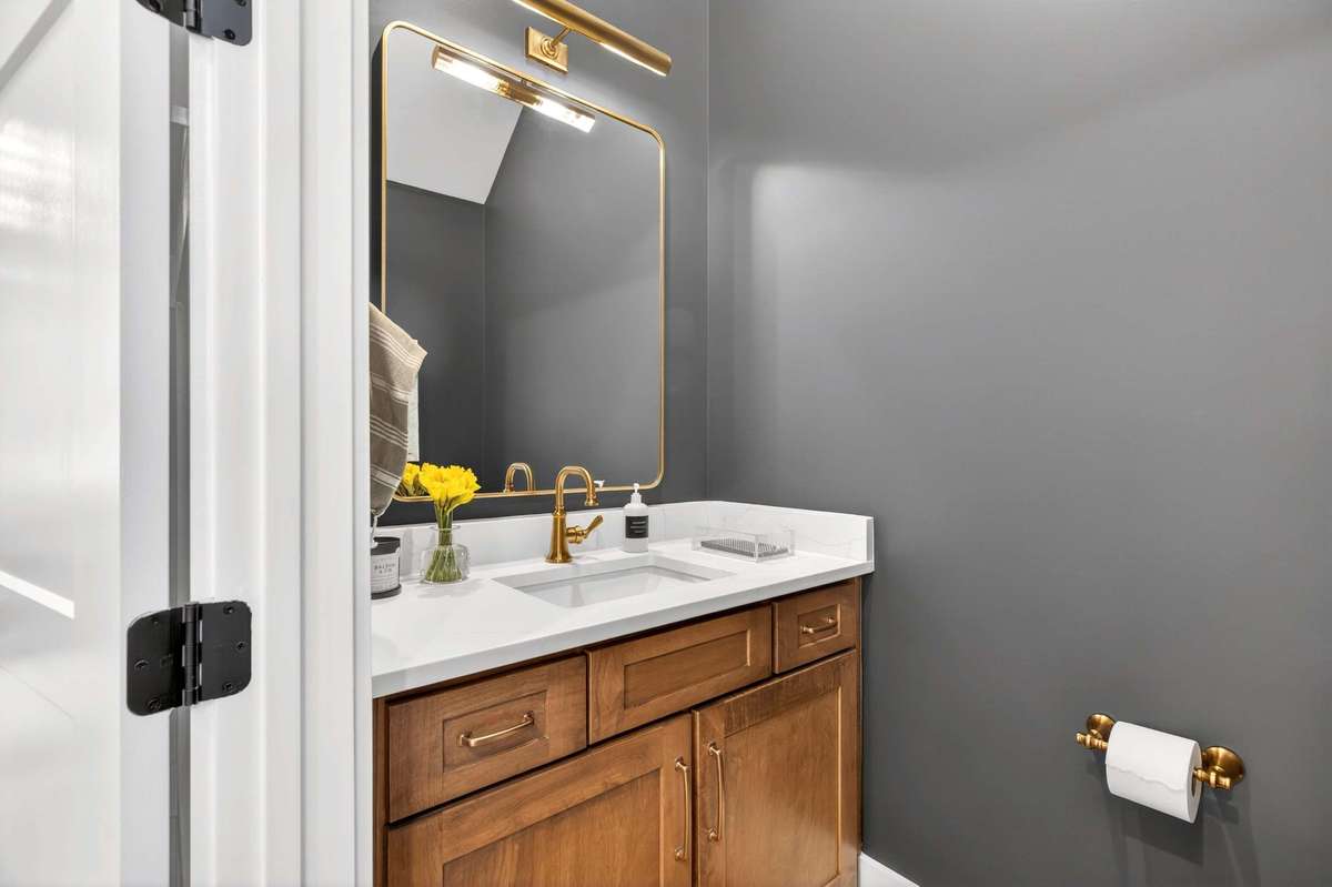 Downstairs powder room located under the entryway stairs