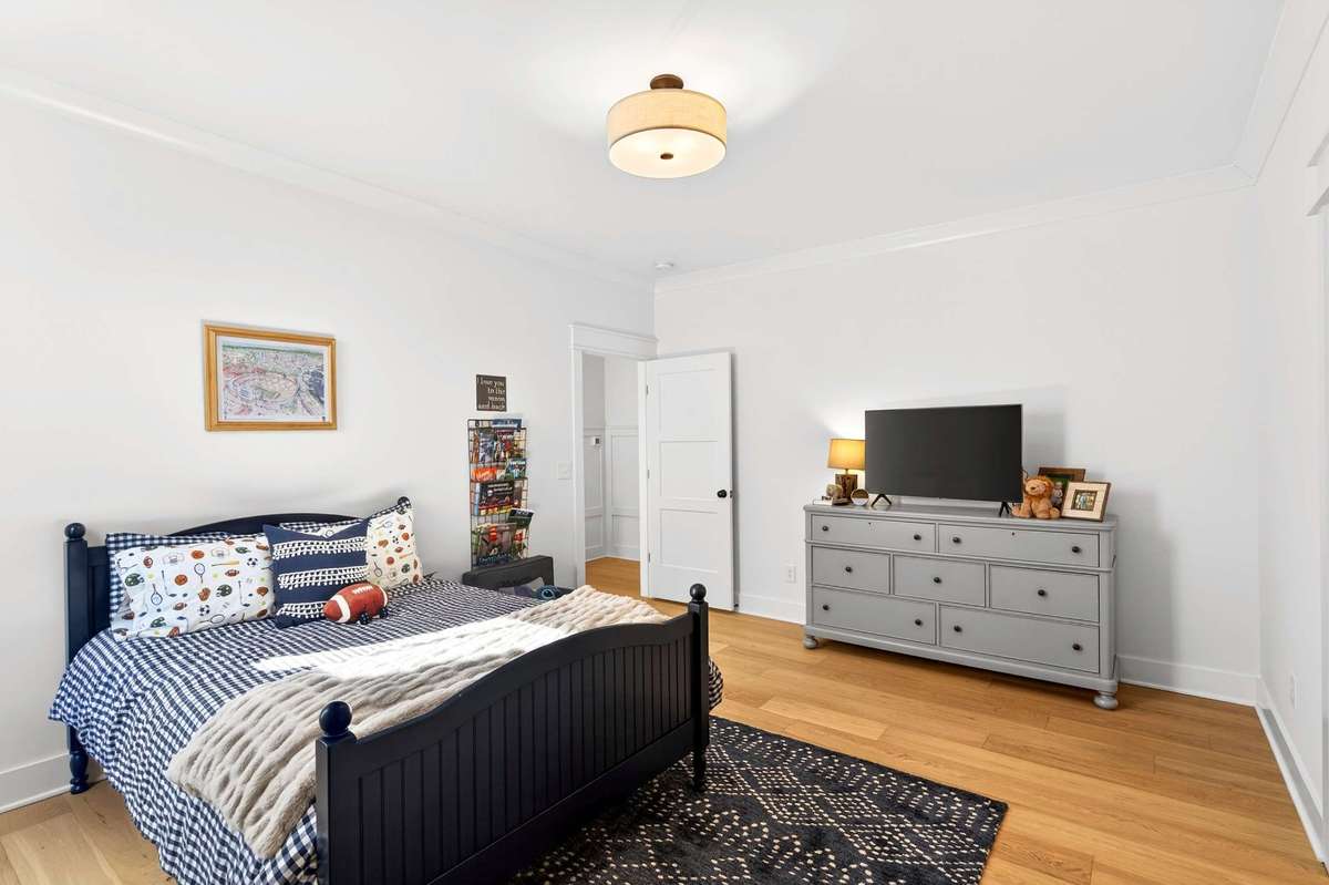 Upstairs Bedroom #1 with upgraded hardwood floors and a large walk-in closet