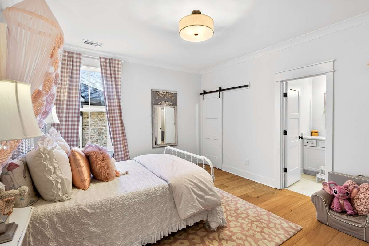 Upstairs Bedroom #2 with a large walk-in closet and hardwood floors