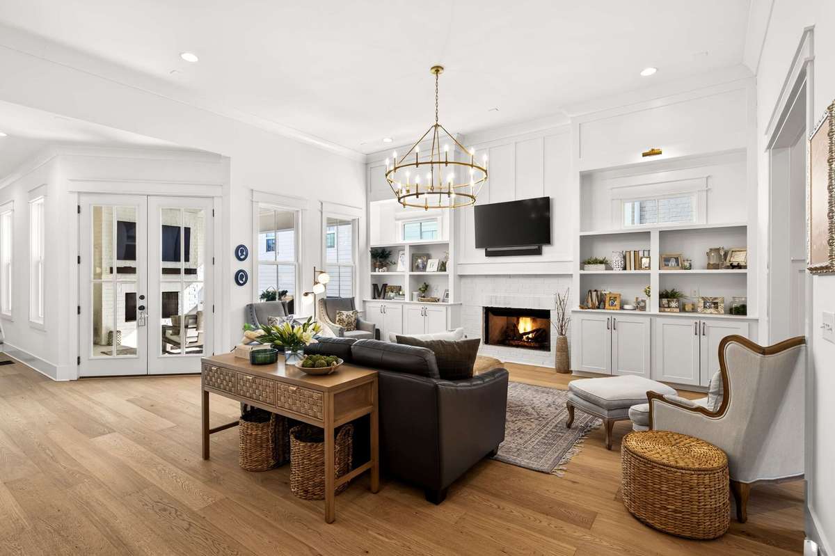This living room offers 12 ft ceilings and opens to the beautiful gourmet kitchen