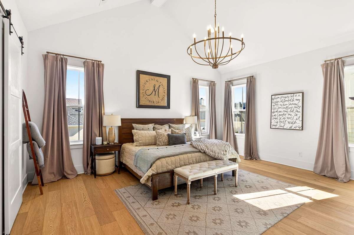 Spacious Primary Suite with vaulted ceilings and His & Hers closets
