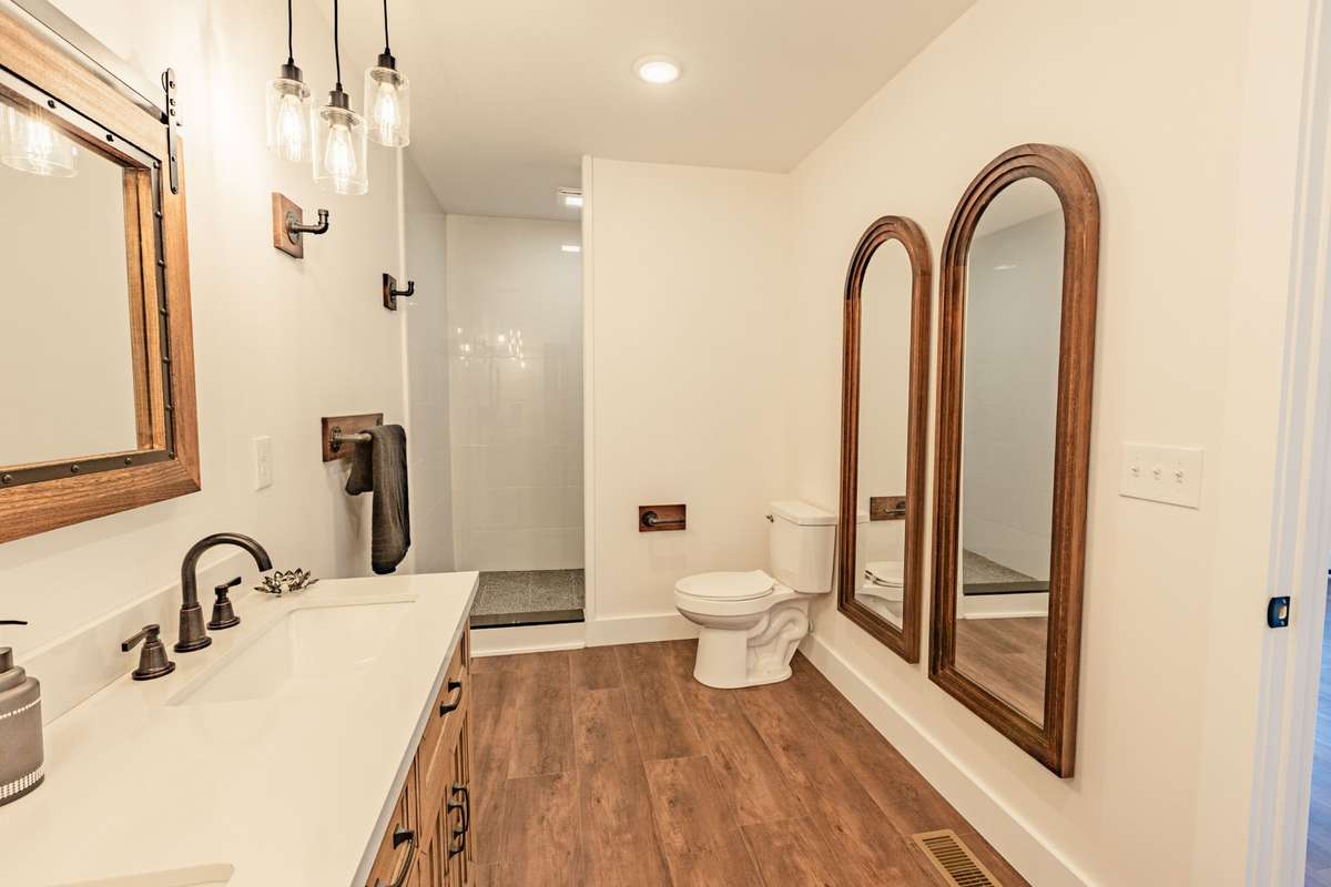 Primary bathroom with double vanities and walk-in shower.