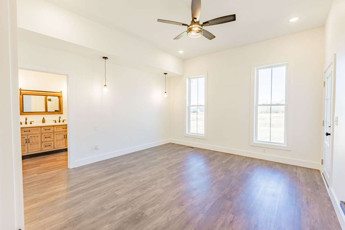 Primary bedroom with access to back porch.