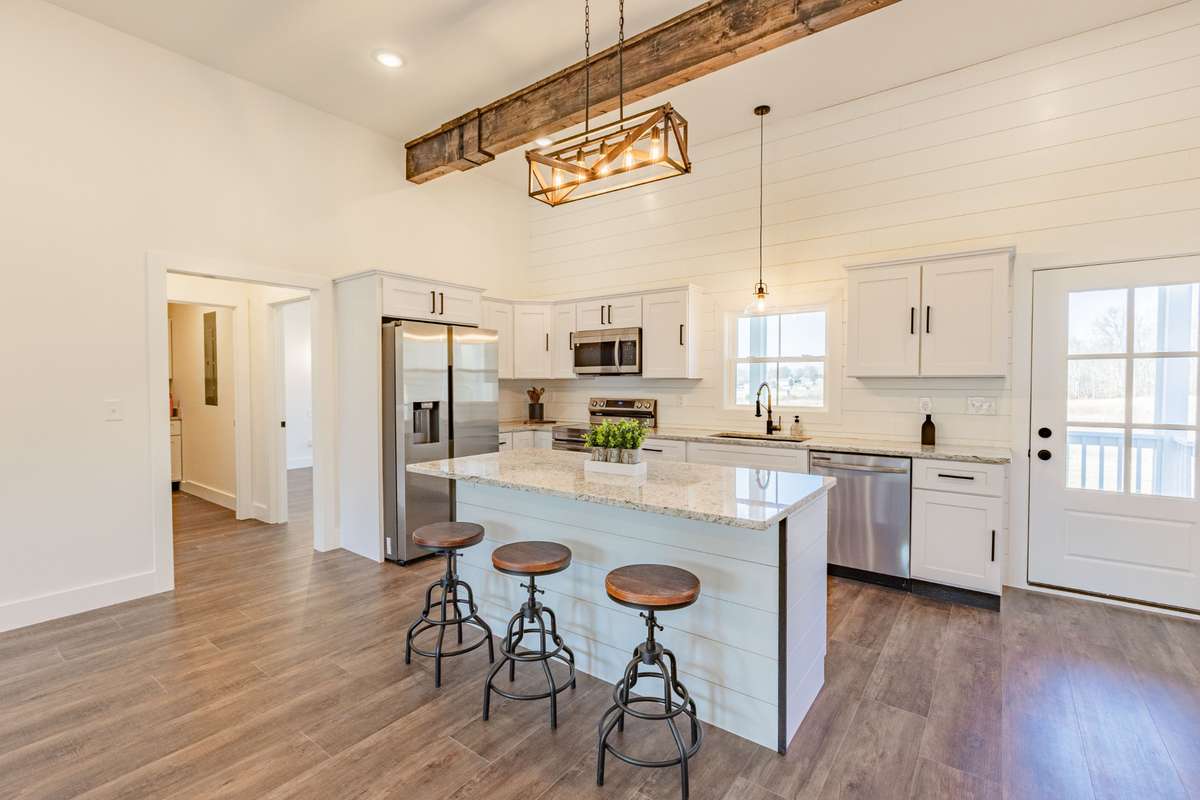 Lovely kitchen with island and stainless steel appliances.