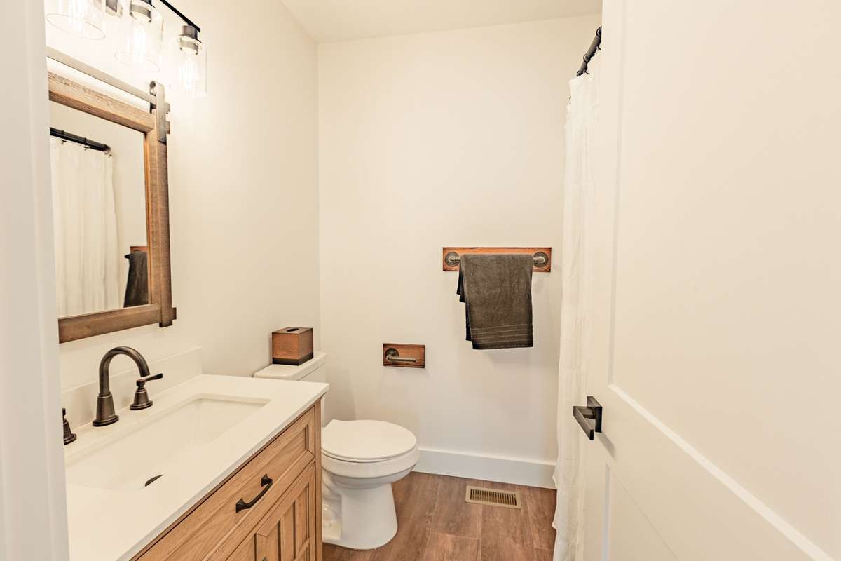 Hall bathroom with combo tub and shower.