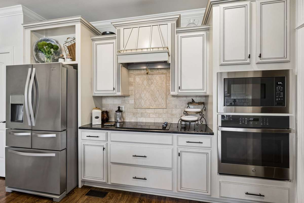 Custom tile detail above cooktop, microwave and oven