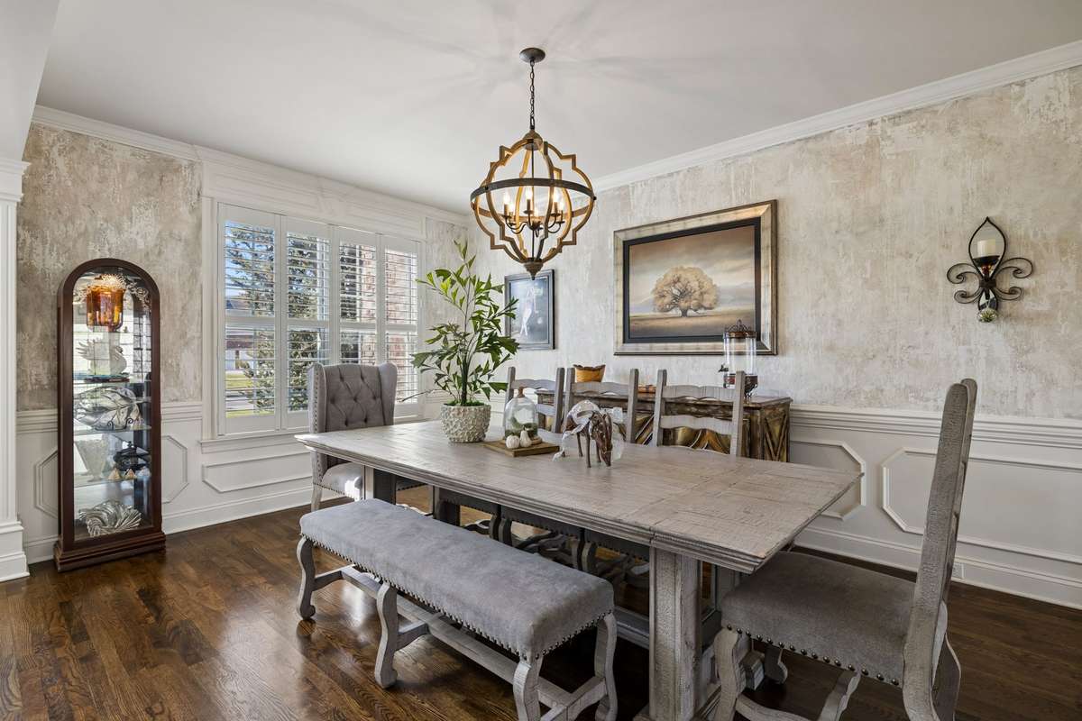 Triple windows with plantation shutters and warmth of hardwood floors