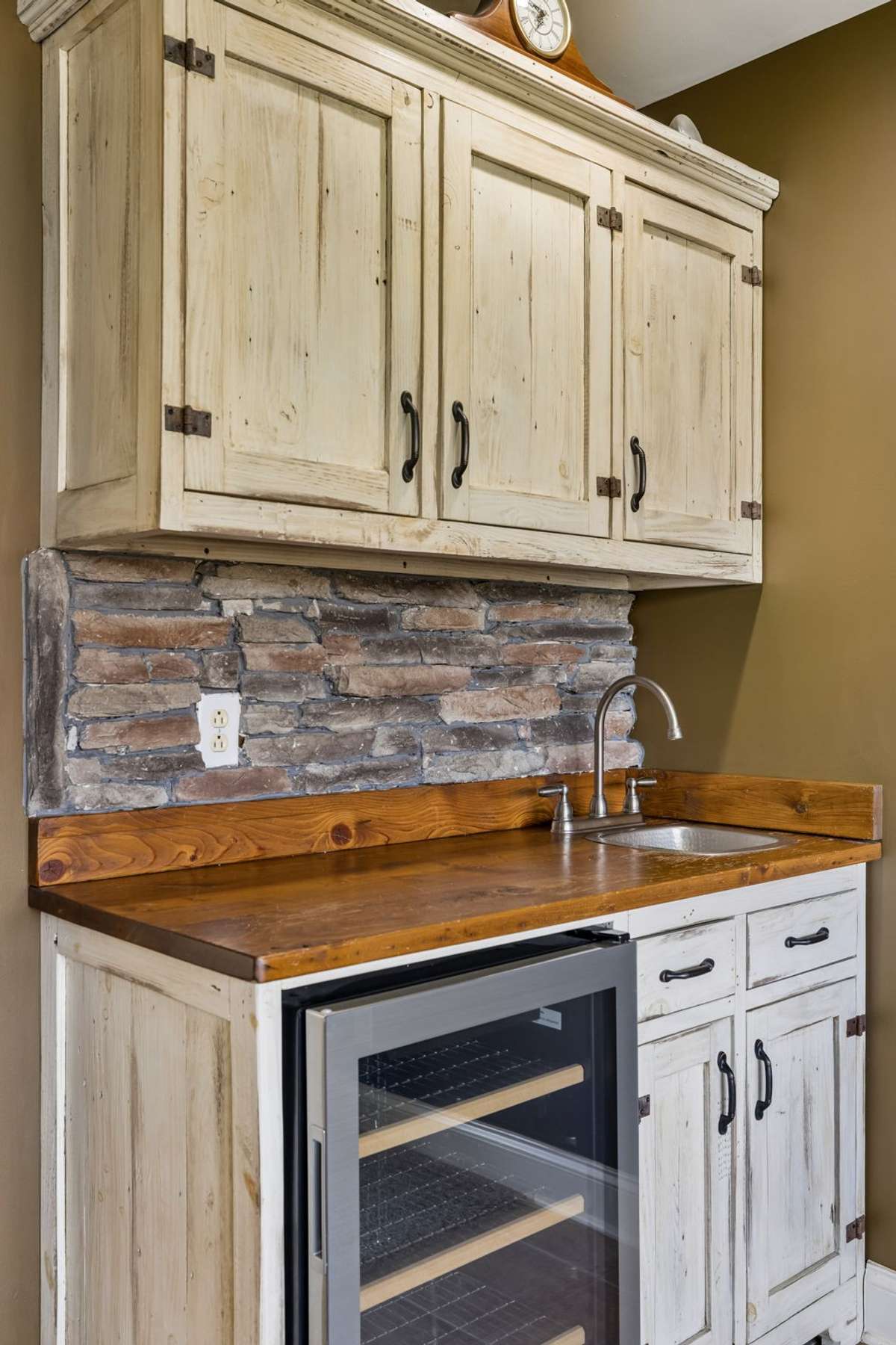 Bonus room includes a wet bar with custom cabinets and mini refrigerator