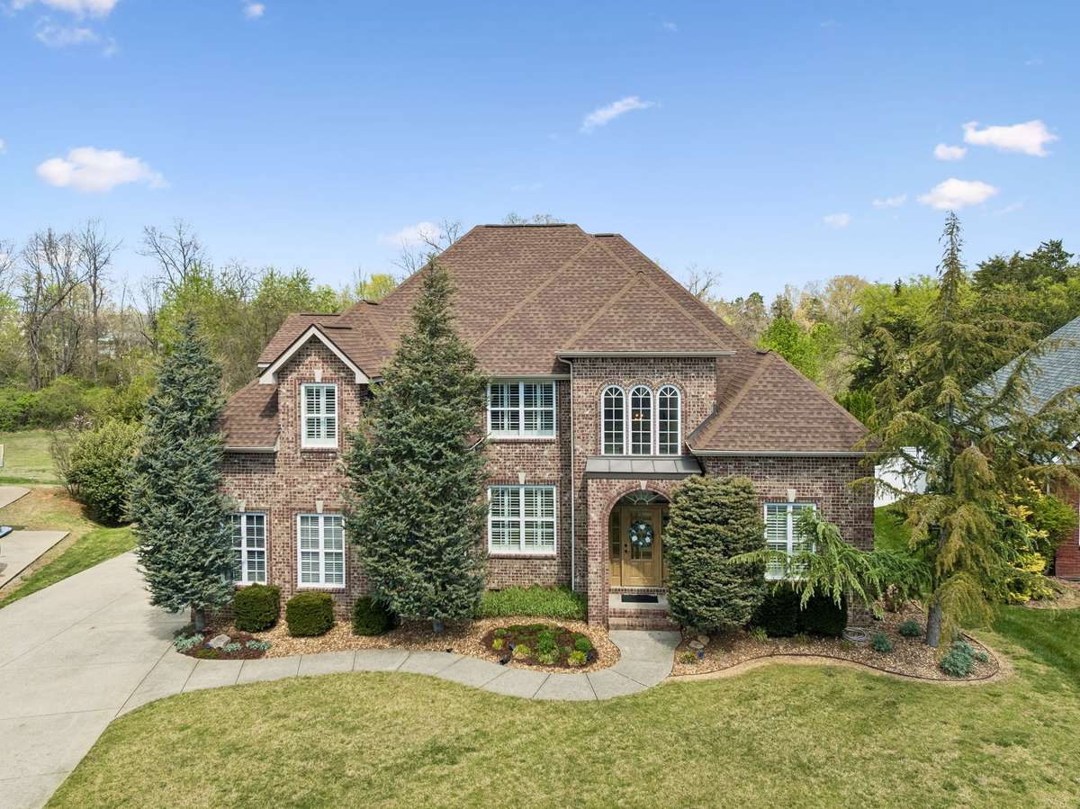 Aerial view of home on cul-de-sac lot with street lights and sidewalks