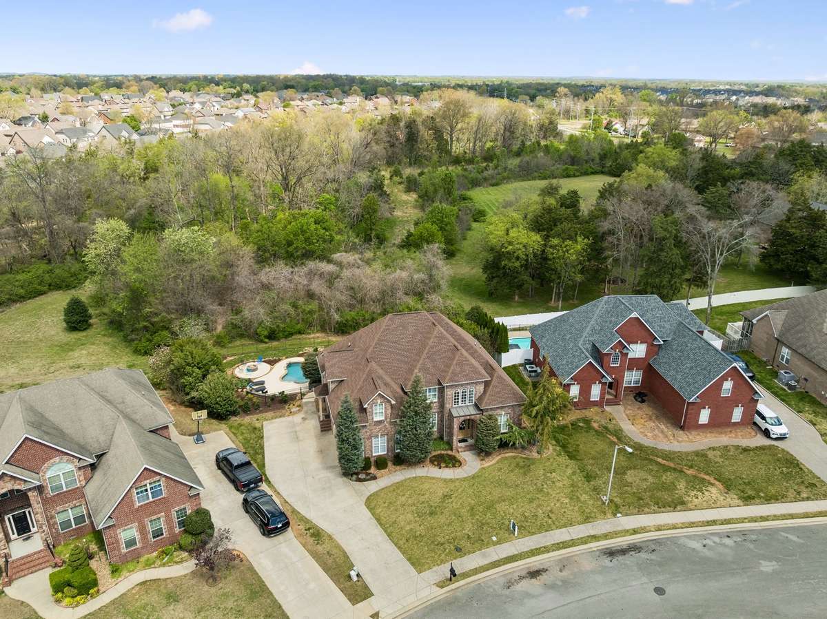 Concrete drive provides parking and sidewalk to front door