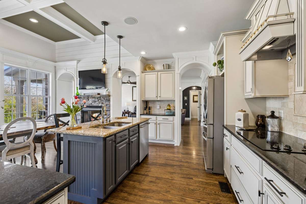 Island with dishwasher and wink with pendant and recessed lighting