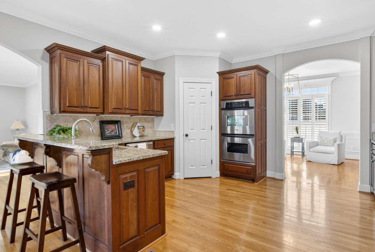 Kitchen flows seamlessly into the rest of the home. Double oven, L-shaped pantry and high end cabinetry throughout all spaces