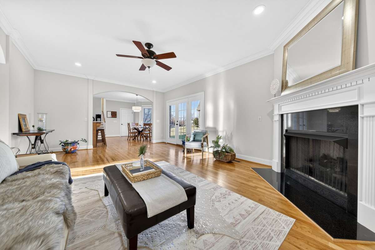 Living room has a gas fireplace and black marble surround