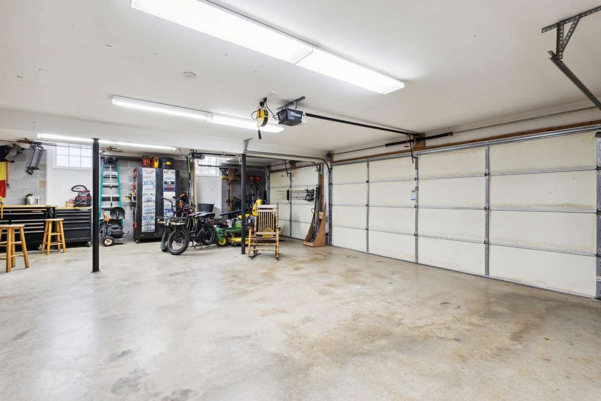 Three car garage accessed off the kitchen, with extra depth and built in shelves