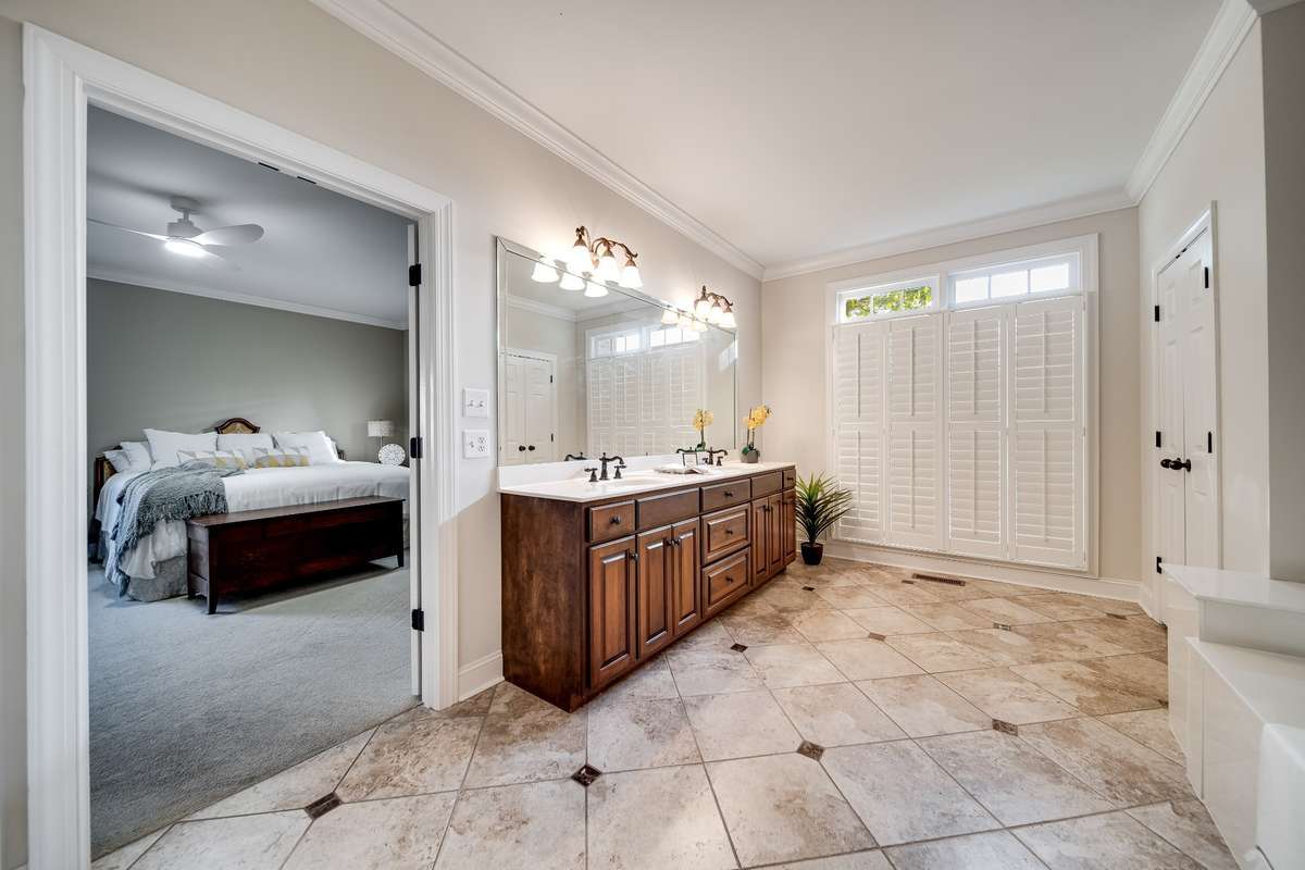 Spacious master bath with plantation shutters, oversize linen closet, 72"x42" marble tub, and separate shower