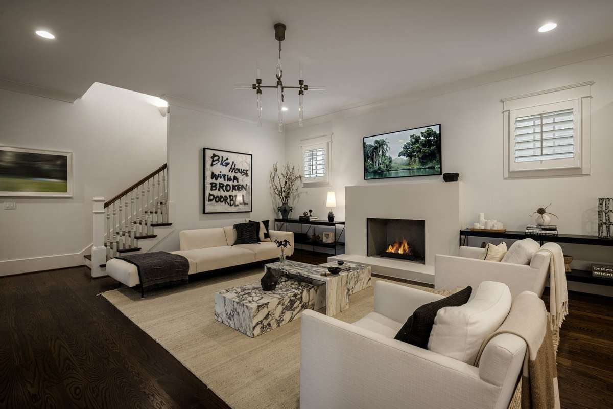 Living room with bespoke fireplace and open connection to the kitchen