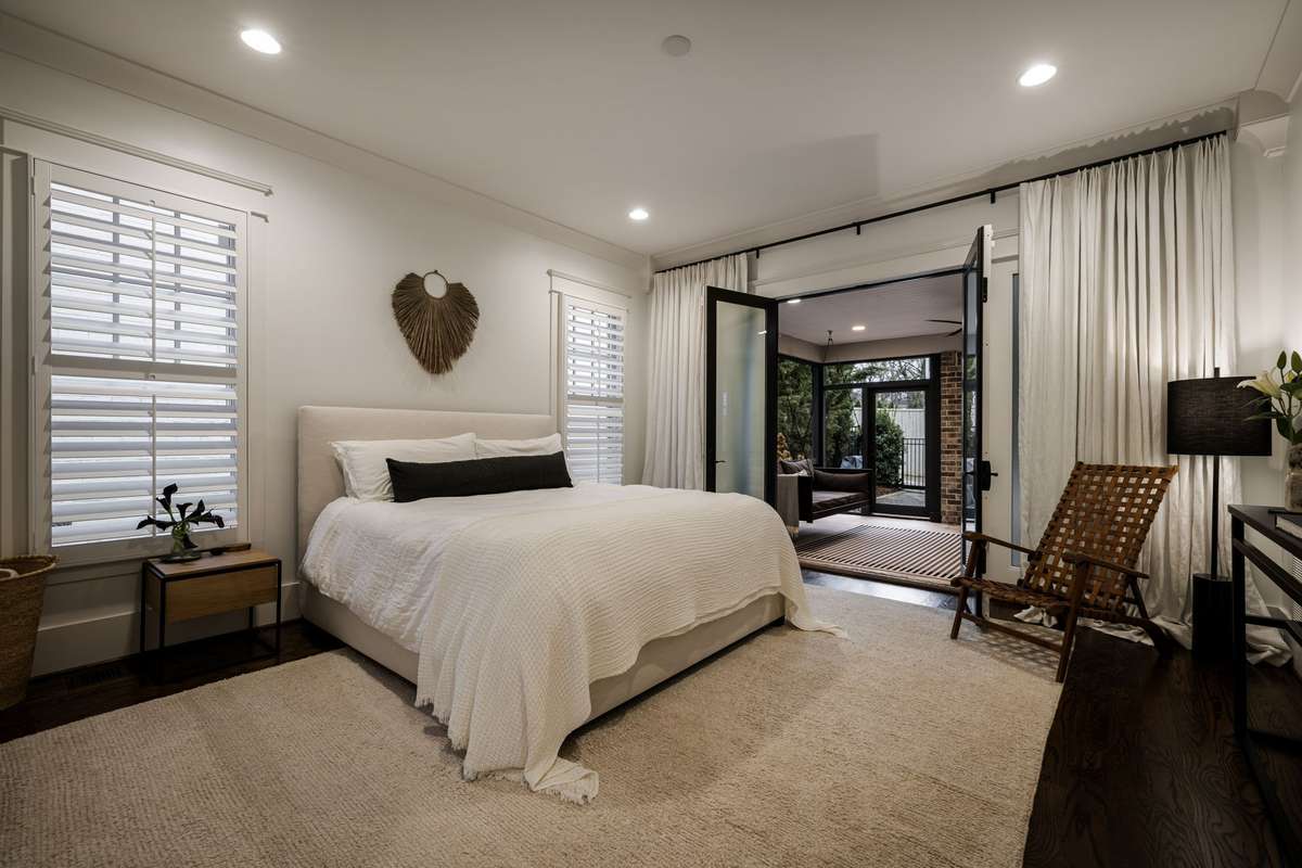 Primary bedroom with direct access to the screened porch