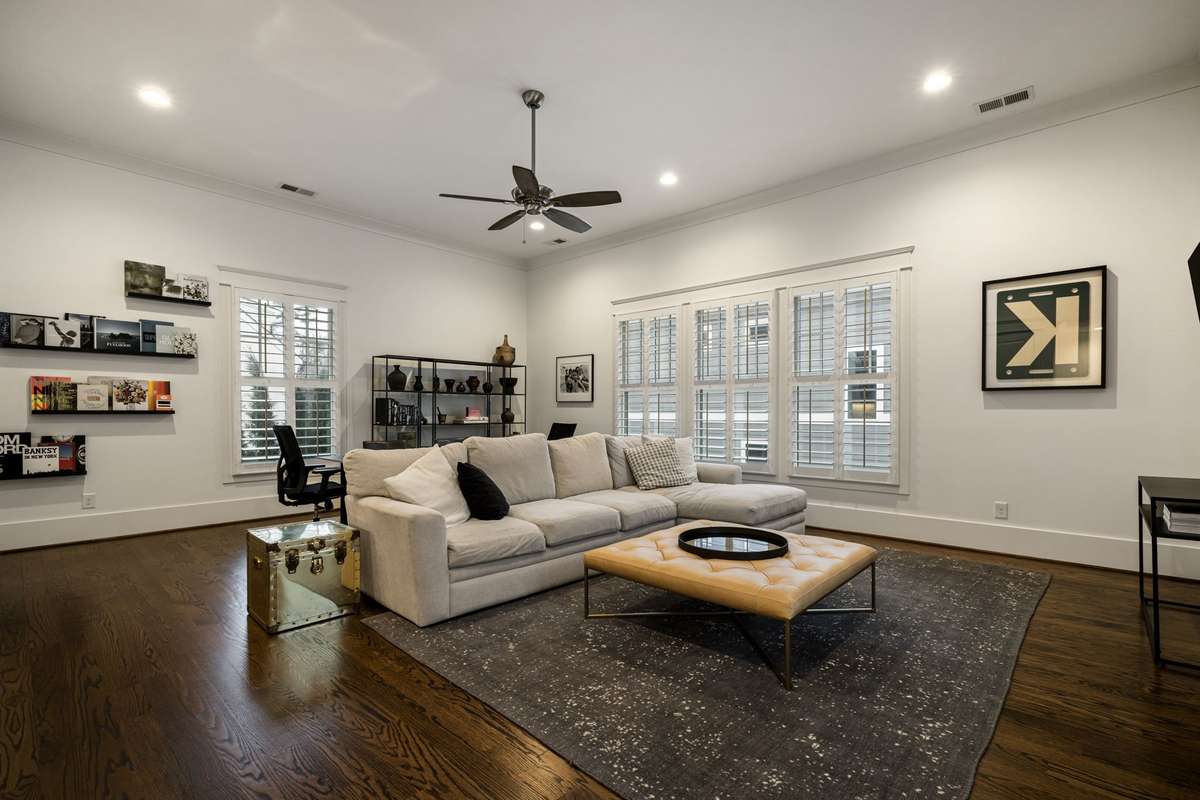 Upper-level bonus room with multiple seating areas and large windows