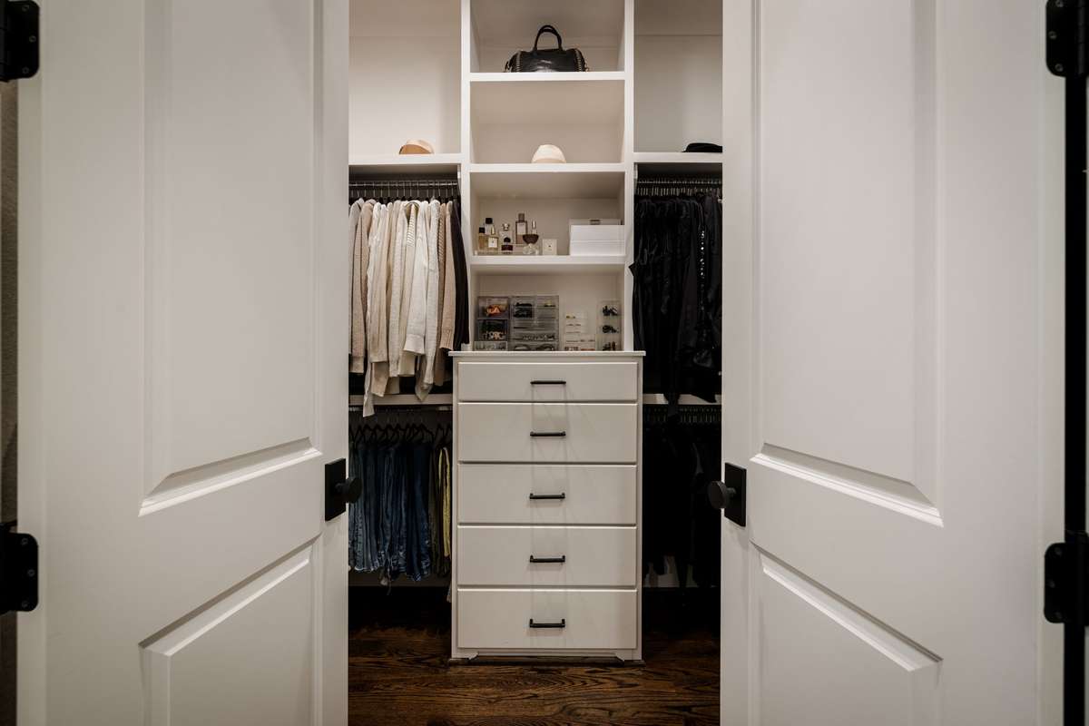 Custom walk-in closet with built-in drawers and shelving