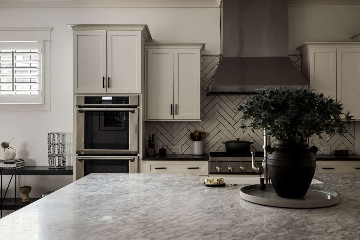 Marble island and herringbone backsplash