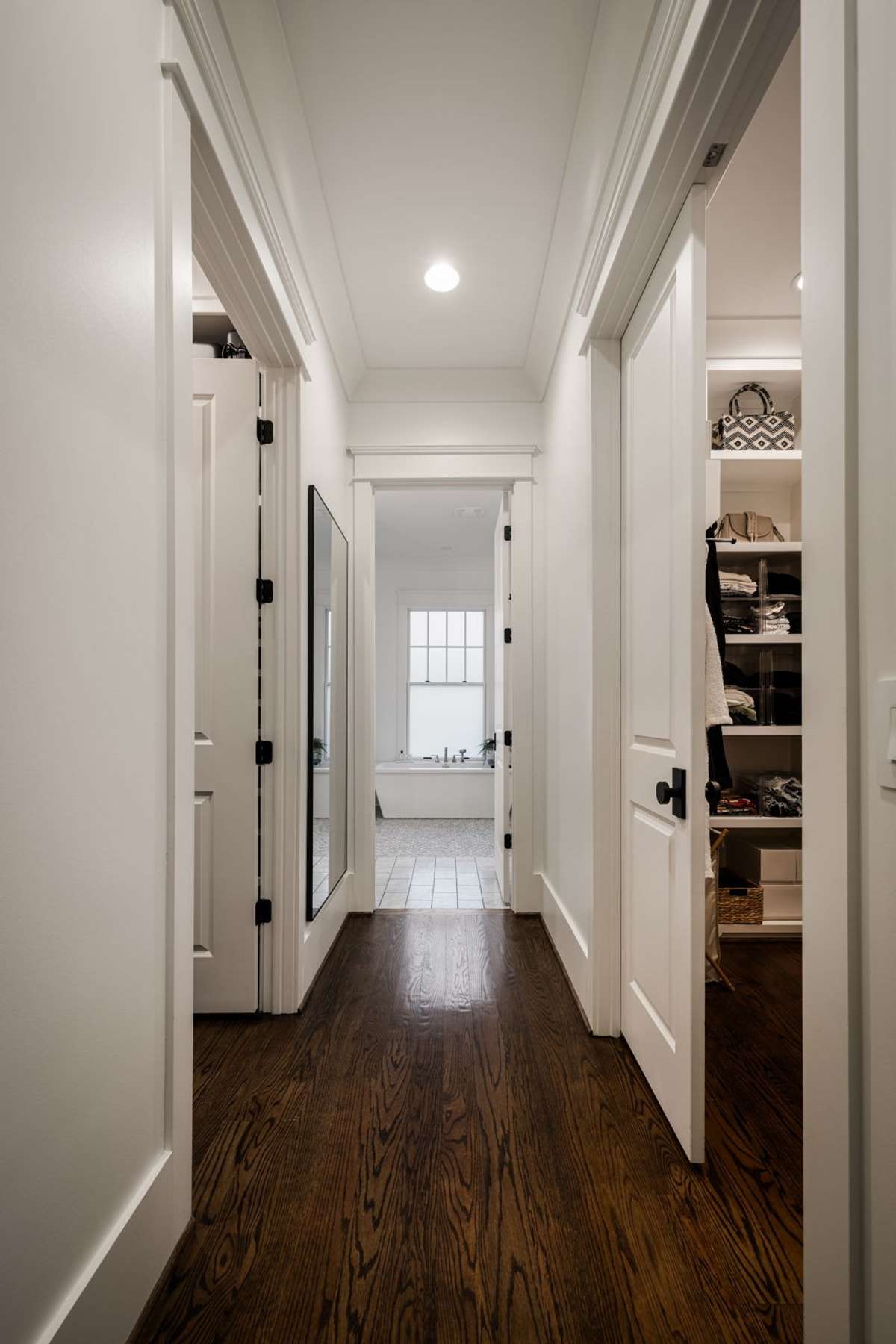 Hallway connecting the primary suite to bath and closet areas